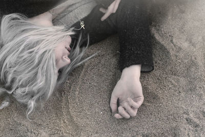 High angle view of woman lying down on bed