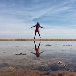 Full length of woman jumping in water