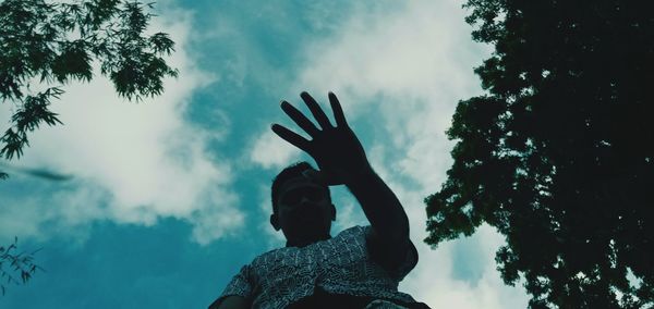 Low angle view of silhouette woman against sky