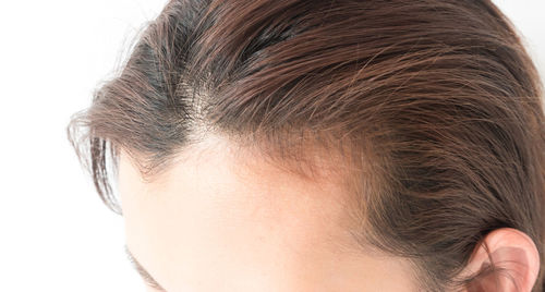 Woman with hair against white background