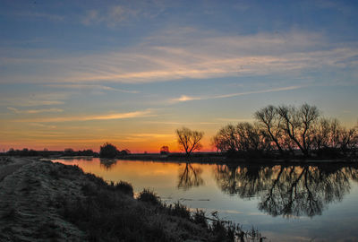 Scenic view of lake against sky during sunset