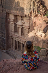 Rear view of woman standing at historical building