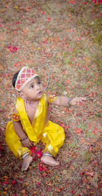 Portrait of young woman sitting on field