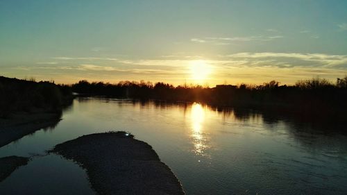 Scenic view of lake against sky during sunset