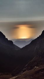 Scenic view of mountains against sky at sunset