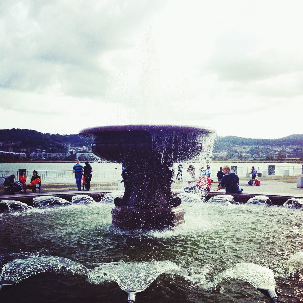 lifestyles, leisure activity, large group of people, person, sky, water, men, cloud - sky, tourist, motion, vacations, enjoyment, splashing, mixed age range, mountain, nature, medium group of people, beach, tourism