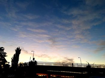 Low angle view of bridge against cloudy sky