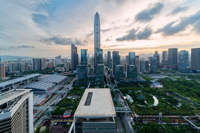 Buildings in city against cloudy sky