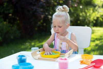 Cute girl sitting on table