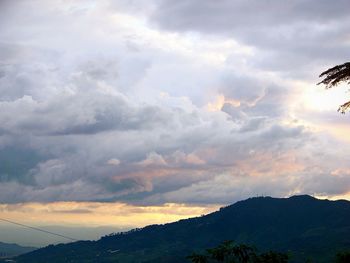 Scenic view of mountains against cloudy sky