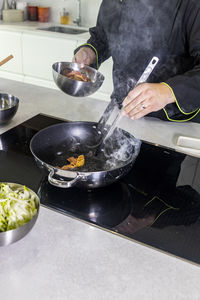 Man preparing food in kitchen at home