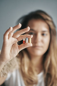 Close-up of woman holding capsules