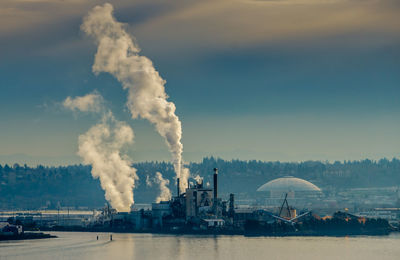 Steam rises from a factory at the port of tacoma.