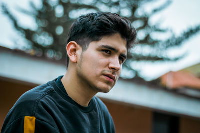 Portrait of young man looking away