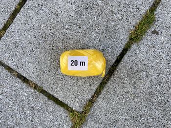 High angle view of yellow sign on road