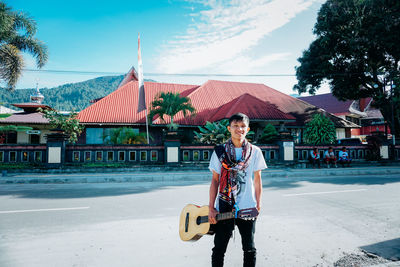 Full length of man standing in city against sky