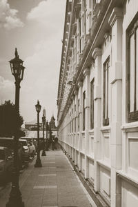 People on street amidst buildings against sky