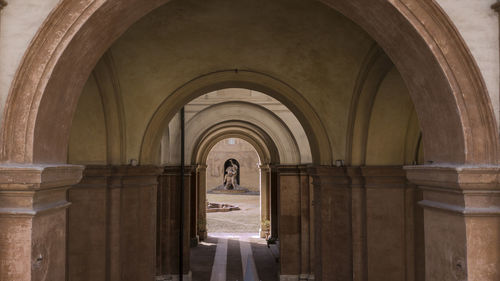 Fron view of corridor of building with archs