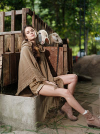 Portrait of woman sitting on field