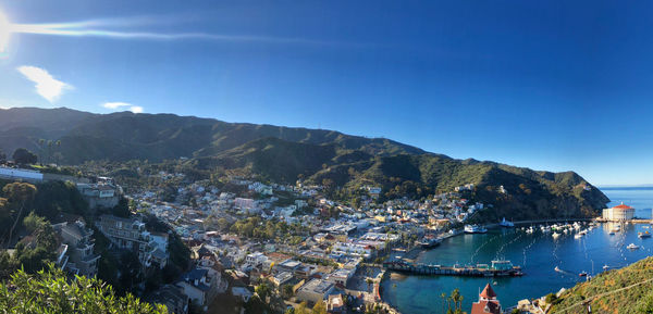 High angle view of townscape by sea against sky