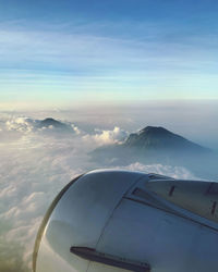 Aerial view of clouds over mountain seen from airplane