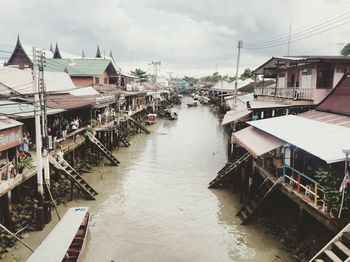 High angle view of boats in sea against buildings