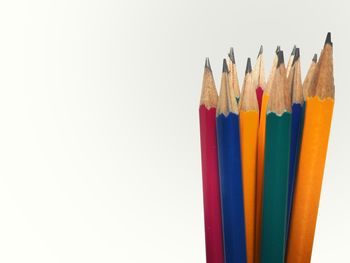 Close-up of colored pencils against white background