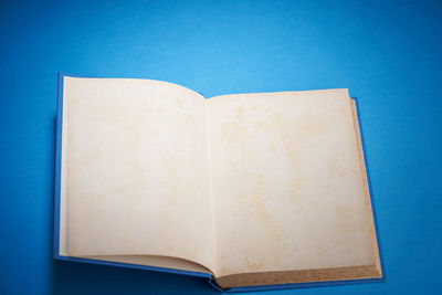 Close-up of open book against blue background