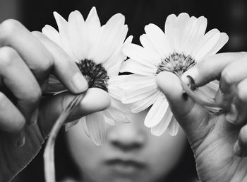 Close-up of hands holding flowers