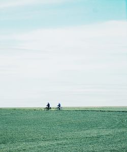 People on field against sky