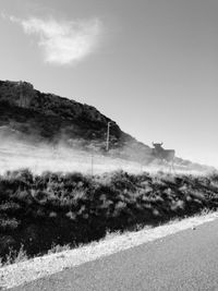 Road by mountain against clear sky