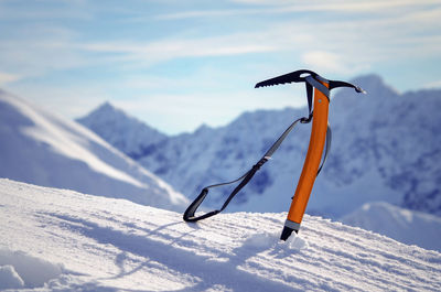 Low angle view of people skiing on snow covered land