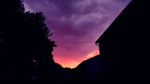 Low angle view of silhouette trees against sky at sunset