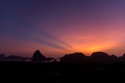 Scenic view of silhouette mountains against sky during sunset