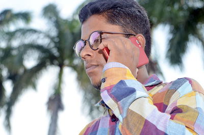 Portrait of young man looking away outdoors