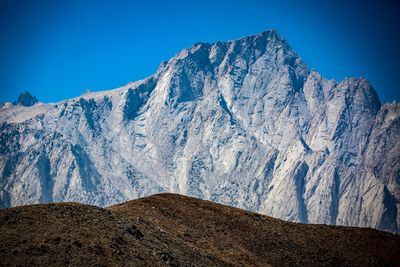 Scenic view of snowcapped mountains against clear blue sky