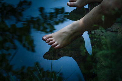 Low section of man legs by lake