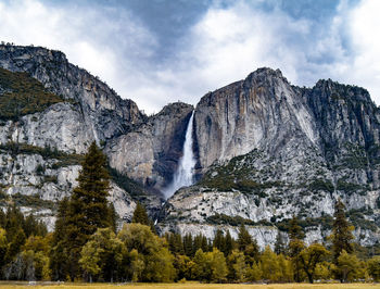 Scenic view of waterfall against sky