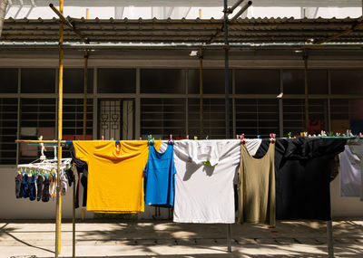 Clothes drying on rope against building