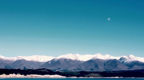 Scenic view of mountains against blue sky