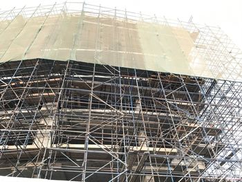 Low angle view of construction site against clear sky