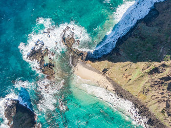 High angle view of sea by rock formation