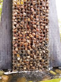 Close-up of rusty metallic structure against wall