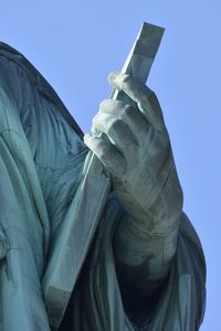 Low angle view of statue against clear blue sky