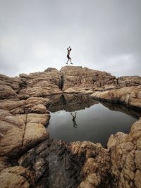 Rear view of man standing on rock