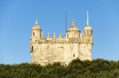 Low angle view of belem tower against clear blue sky