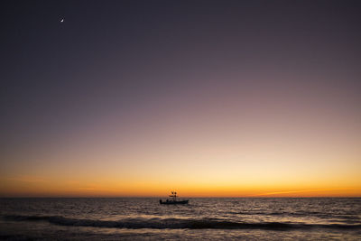 Scenic view of sea against clear sky during sunset