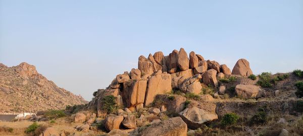 Rock formations on landscape against clear sky