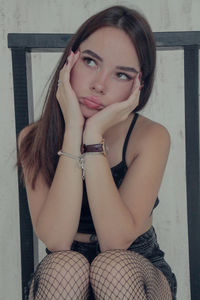 Portrait of young woman sitting outdoors