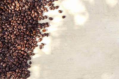 High angle view of coffee beans on wooden table